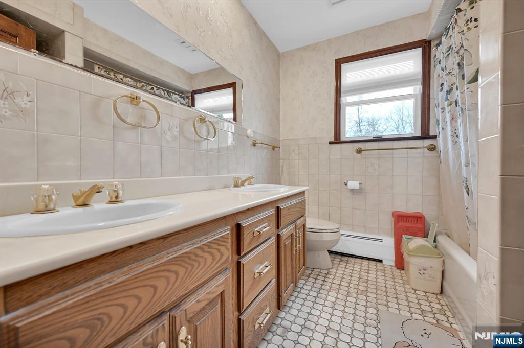 699 Shore Road West Milford, NJ 07421 - Photo 35 of 50 a bathroom with a sink a toilet and a shower