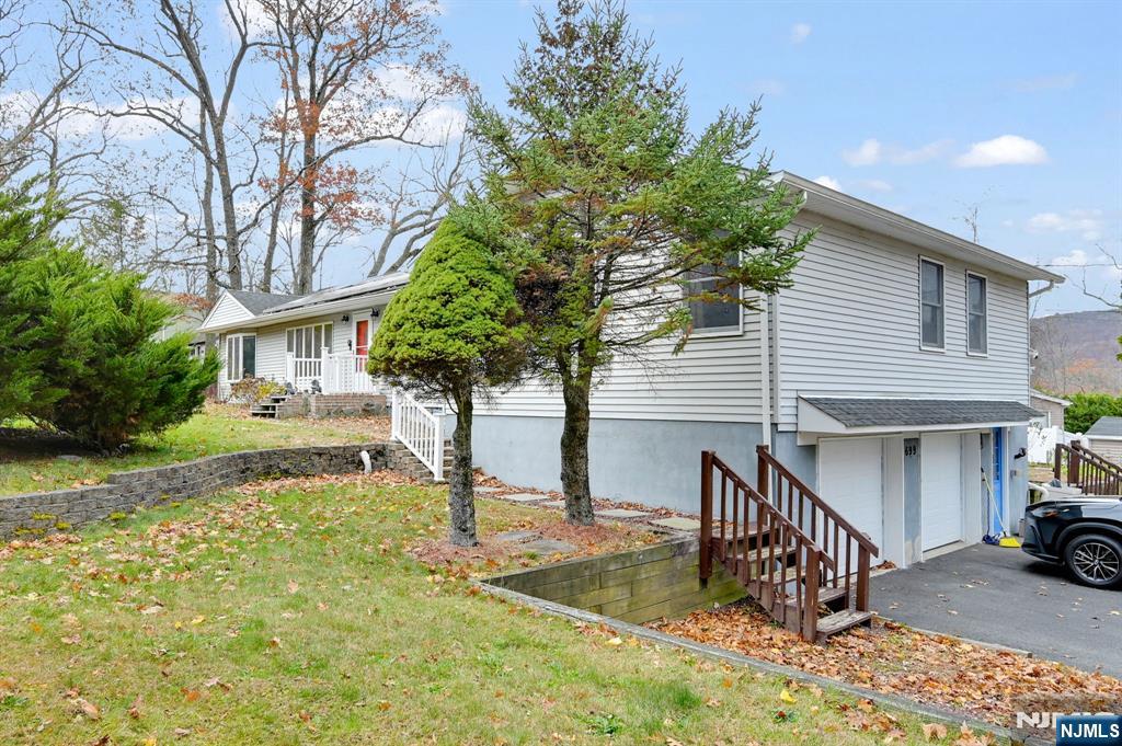699 Shore Road West Milford, NJ 07421 - Photo 44 of 50 a front view of a house with garden