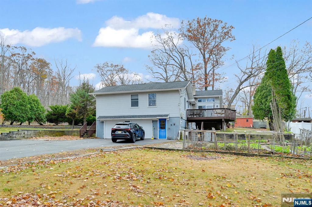 699 Shore Road West Milford, NJ 07421 - Photo 45 of 50 a car parked in front of a house