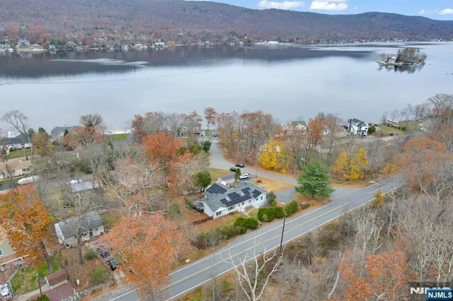 an aerial view of a house with a lake view