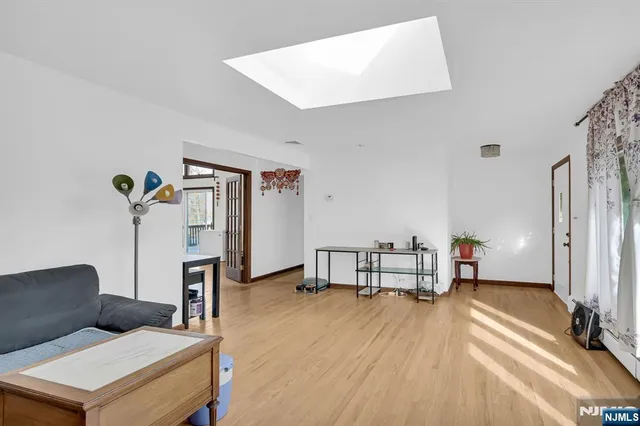 a bedroom with furniture and a wooden floor