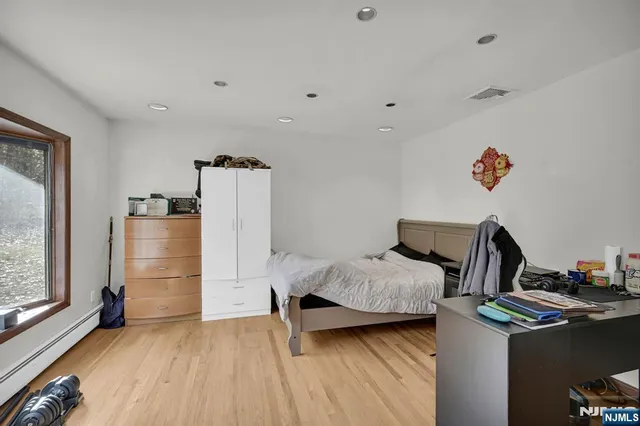 a bedroom with furniture and a window