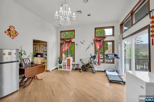 a view of a livingroom with workspace and a window