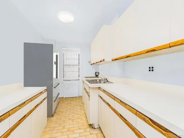 a kitchen with a stove and a wooden floor