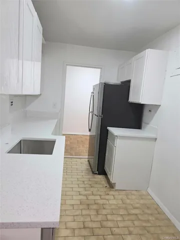a kitchen with a refrigerator and a sink