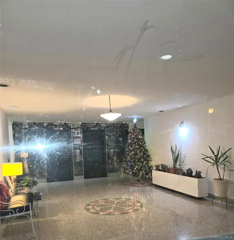 a view of a lobby with a couch and chairs