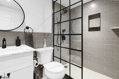 a bathroom with a sink toilet and a mirror