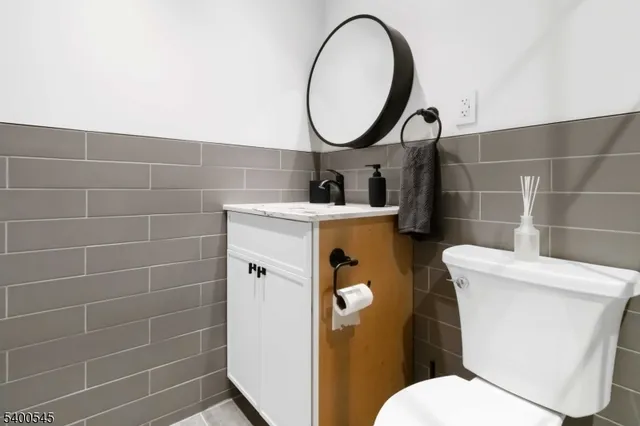 a bathroom with a toilet and a mirror