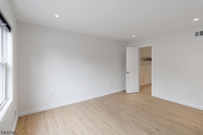 22 Heritage Drive, Unit C Chatham, NJ 07928 - Photo 13 of 27 an empty room with wooden floor and windows