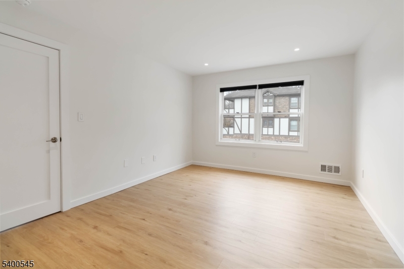 22 Heritage Drive, Unit C Chatham, NJ 07928 - Photo 14 of 27 an empty room with wooden floor and windows