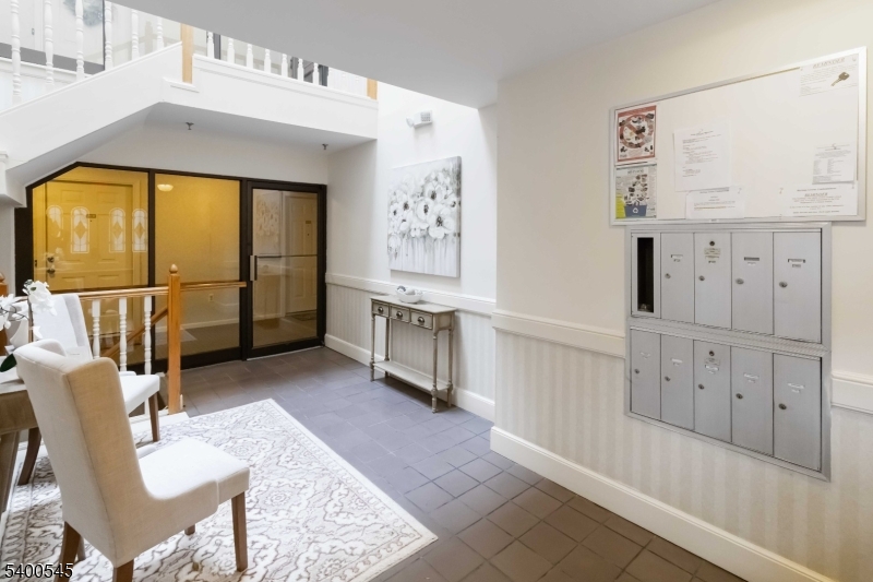 22 Heritage Drive, Unit C Chatham, NJ 07928 - Photo 24 of 27 a living room with furniture and a large window