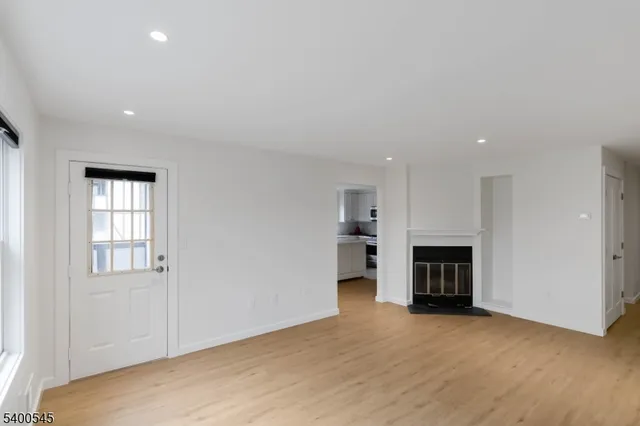 a view of empty room with a fireplace and cabinet