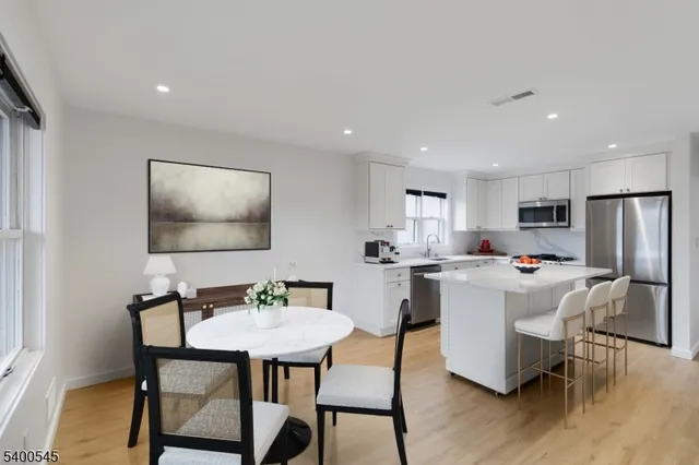 a view of kitchen with cabinets and wooden floor