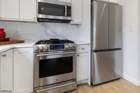 a stove top oven sitting inside of a kitchen