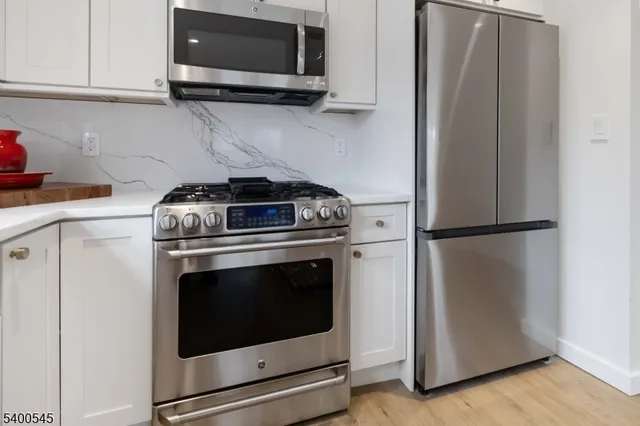 a stove top oven sitting inside of a kitchen