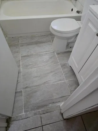 a bathroom with a toilet and a shower