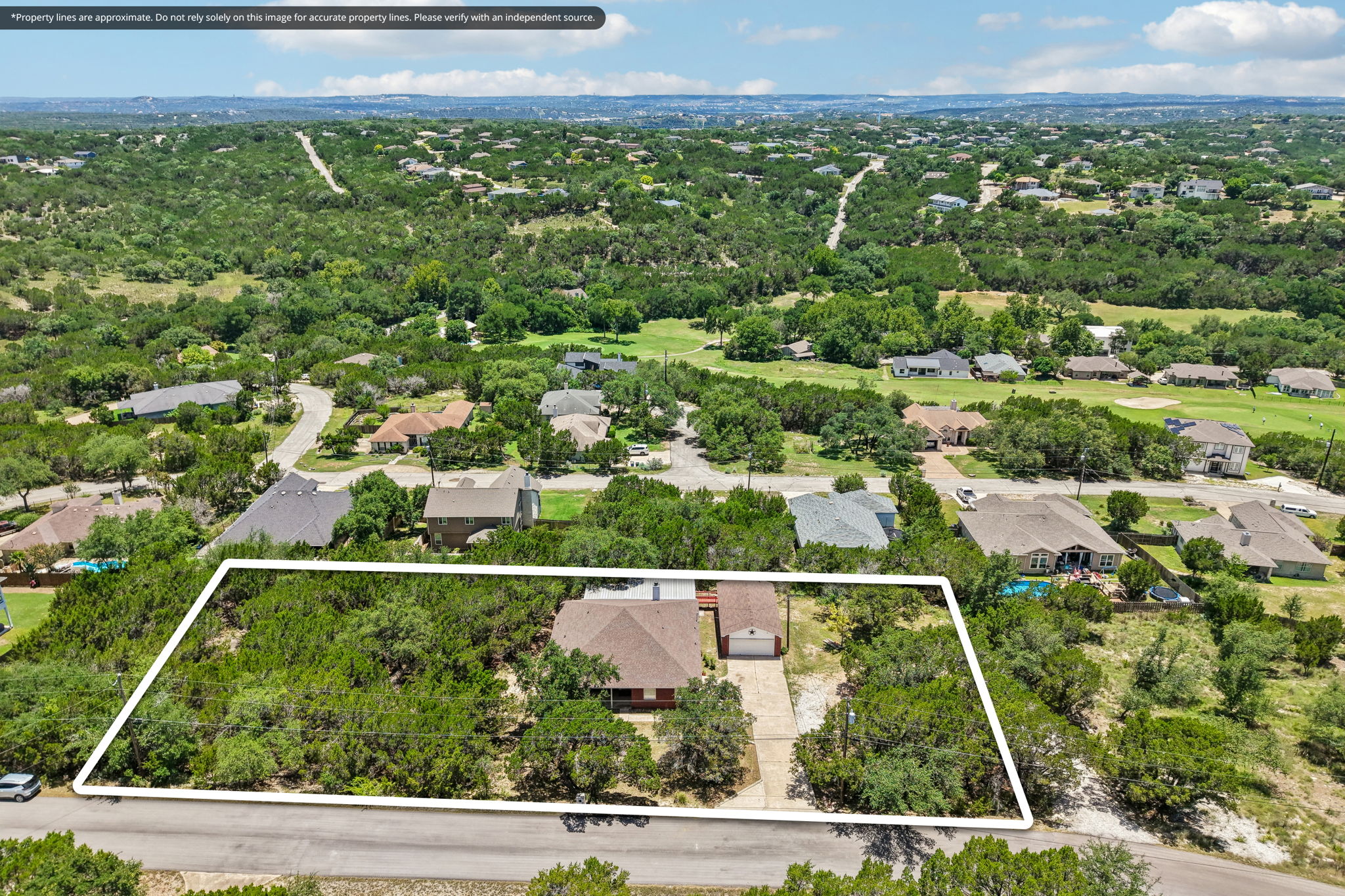 20609 Bridle Path Road Lago Vista, TX 78645 - Photo 10 of 30 An aerial perspective showcases a residential area with lush tree coverage and expansive golf course views.