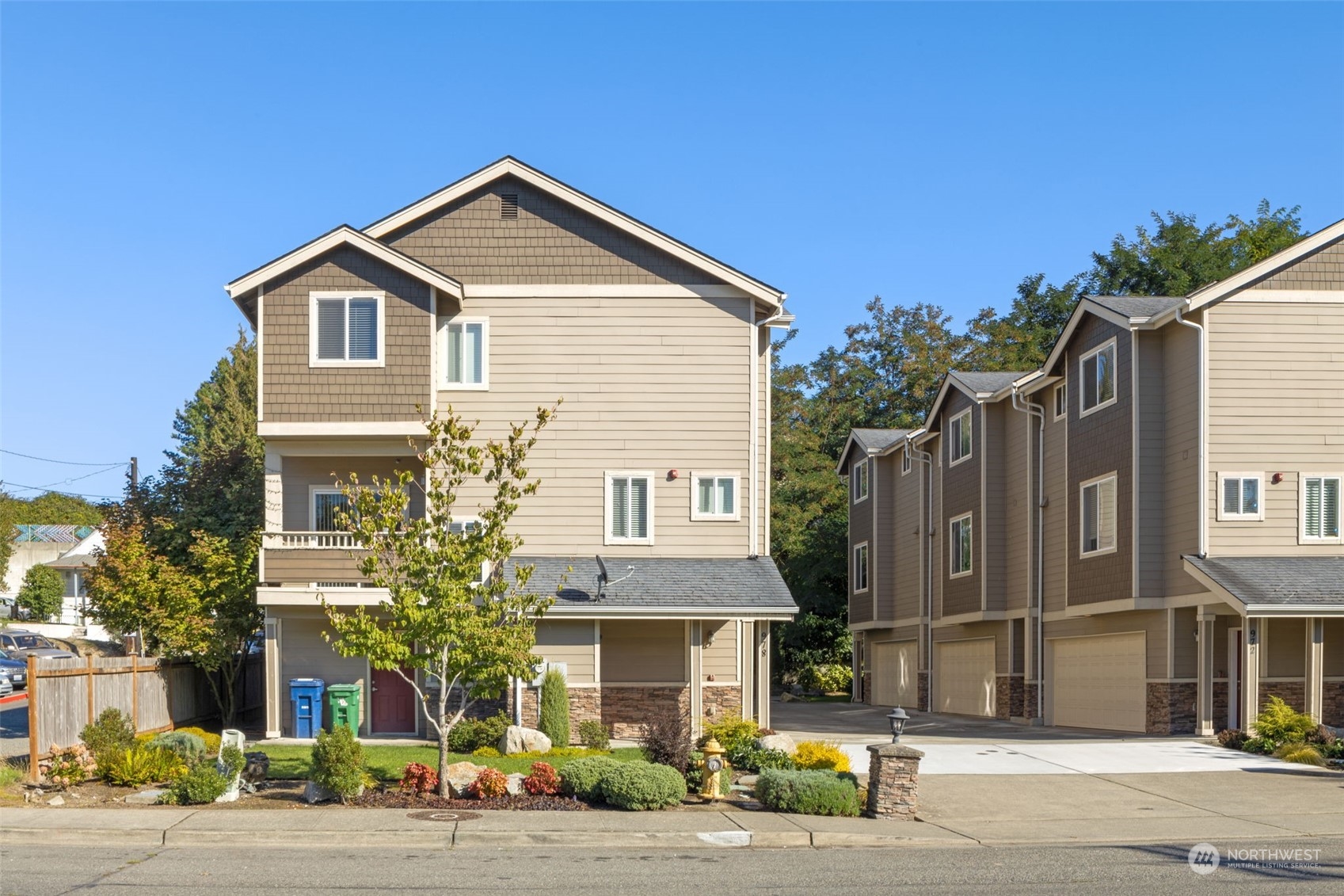 978 Edmonds Avenue Northeast Renton, WA 98056 - Photo 1 of 18 a front view of a house with a road