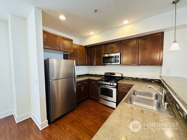 978 Edmonds Avenue Northeast Renton, WA 98056 - Photo 11 of 18 a kitchen with wooden cabinets and stainless steel appliances
