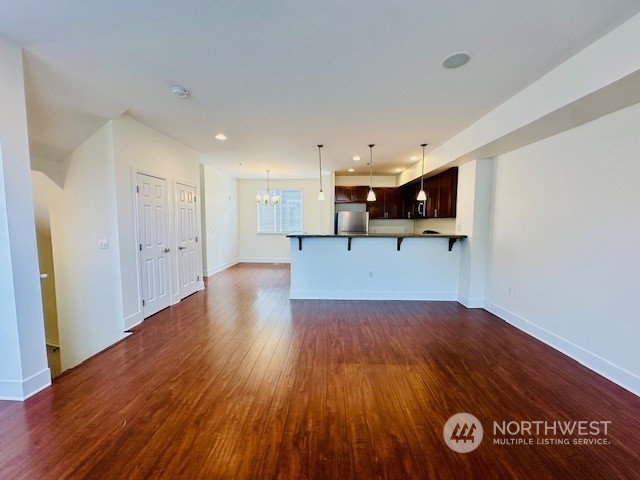 978 Edmonds Avenue Northeast Renton, WA 98056 - Photo 12 of 18 a view of empty room with wooden floor