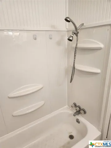 a bathroom with a white bath tub