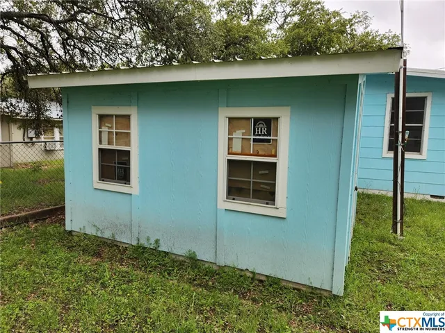 a view of a backyard with a large tree