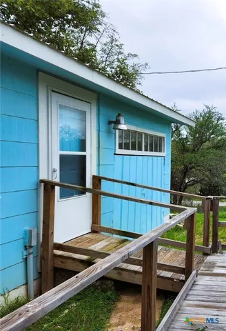 a view of backyard with wooden deck and furniture