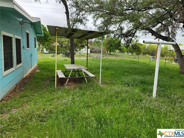 a view of a backyard with large trees