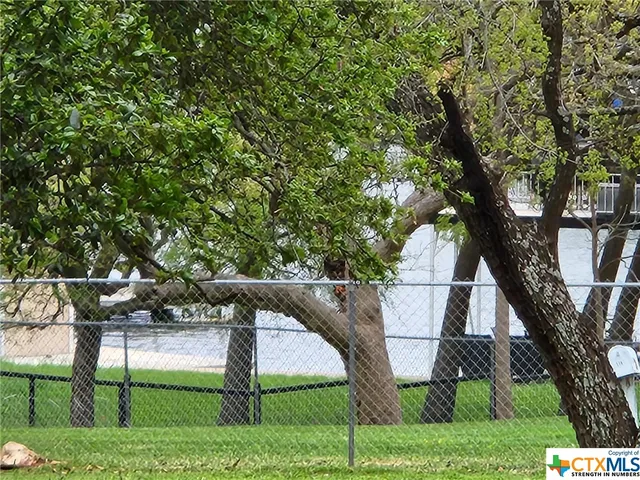 a view of a lake with houses in the background