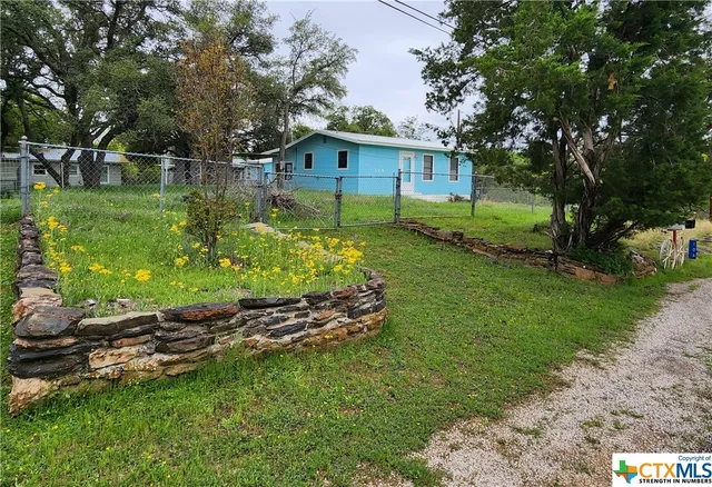 a view of a house with a yard and a garden