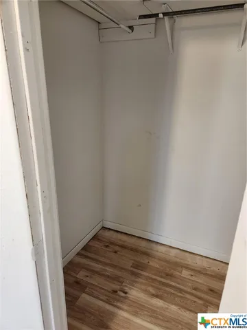 a view of a room with wooden floor