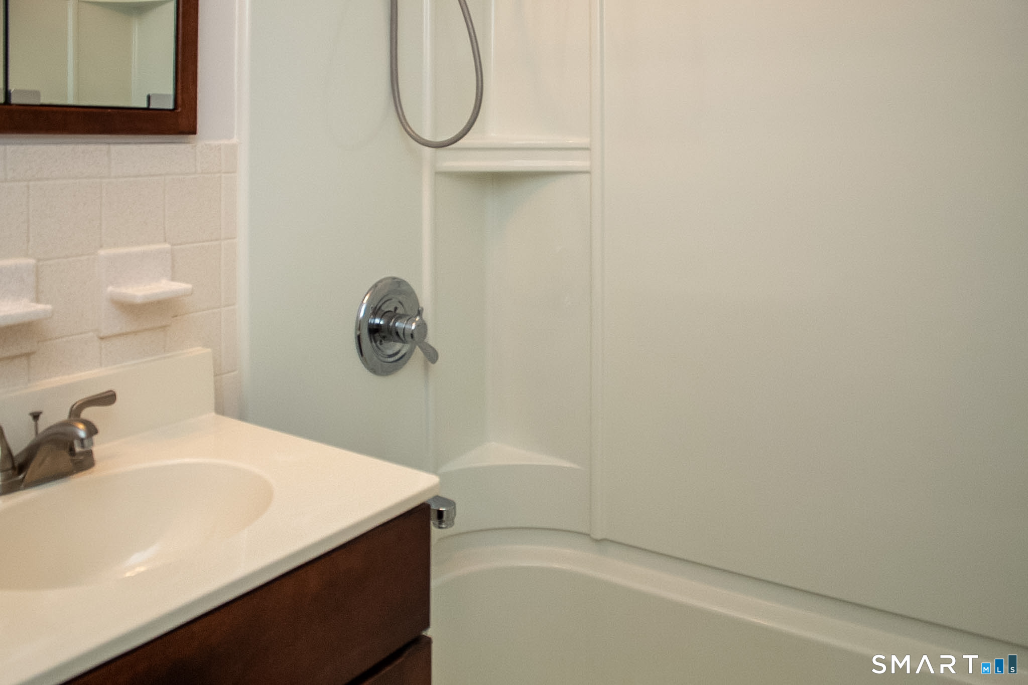 10 Georgetown Drive, Unit J Enfield, CT 06082 - Photo 8 of 15 a bathroom with a sink and a mirror