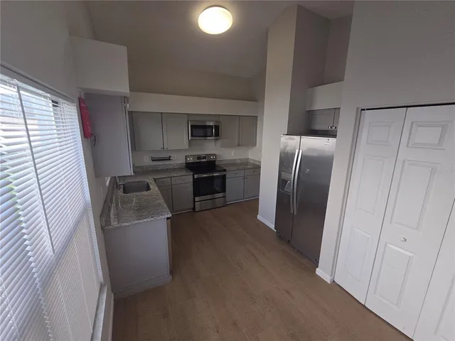 a kitchen with stainless steel appliances granite countertop a stove microwave and oven