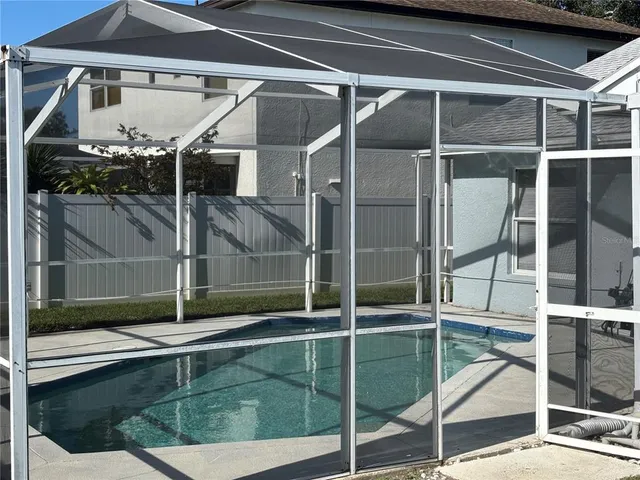 a living room with furniture and floor to ceiling window