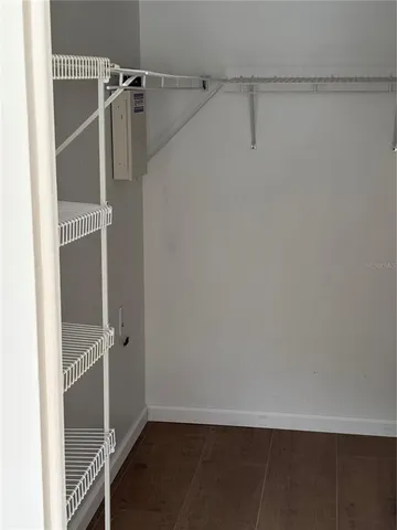 a bathroom with a granite countertop sink and mirror with bathtub