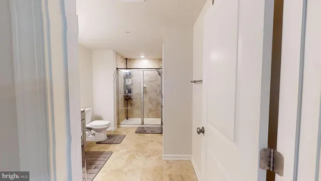 a bathroom with a shower toilet and sink