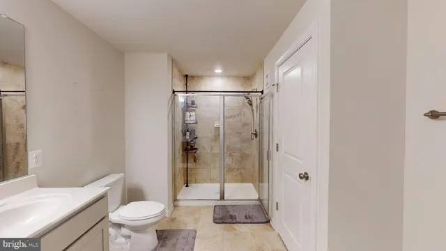 a bathroom that has a glass shower door