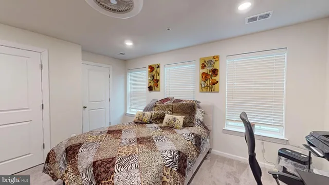 a bedroom with a bed and a television