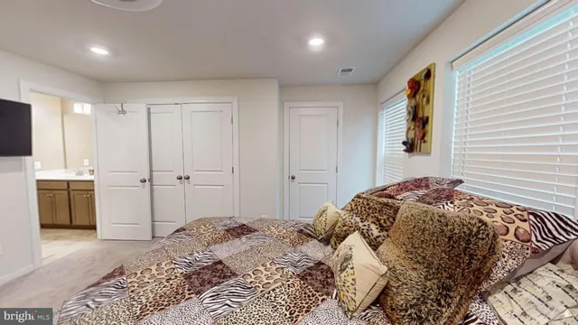 a room with a bed and a dresser