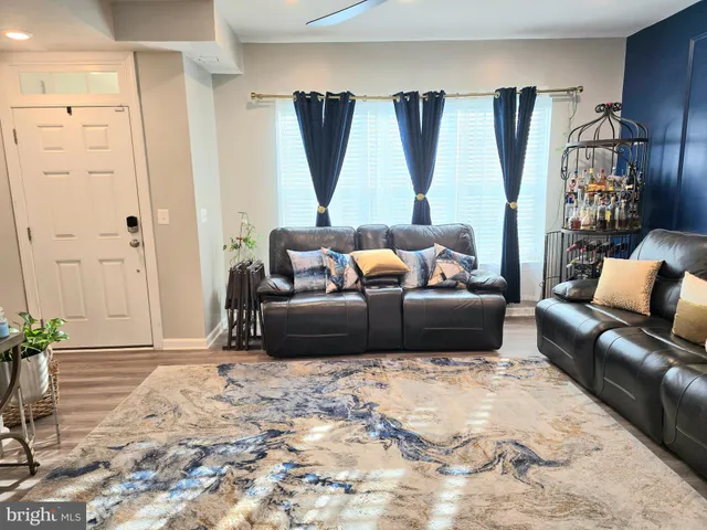 a living room with a bed and a dresser