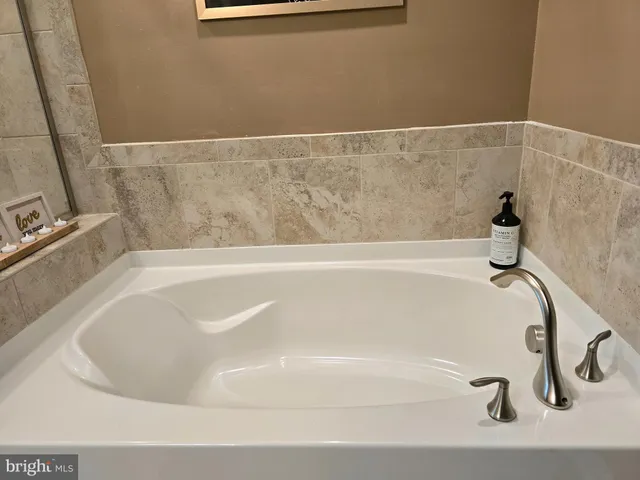 a bedroom with a bed and windows