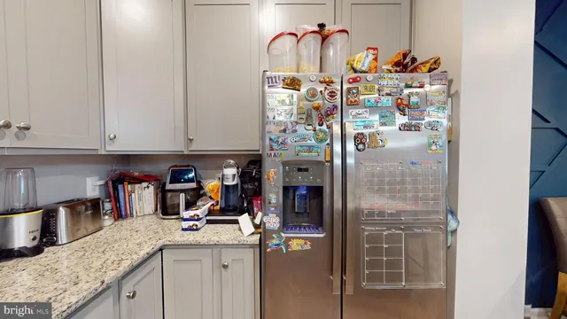 a kitchen with stainless steel appliances granite countertop a sink and cabinets
