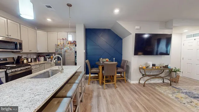 a kitchen with stainless steel appliances granite countertop sink microwave and wooden cabinets