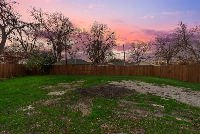 a view of a house with yard and a garden