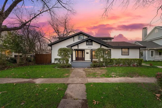 a front view of a house with yard and green space
