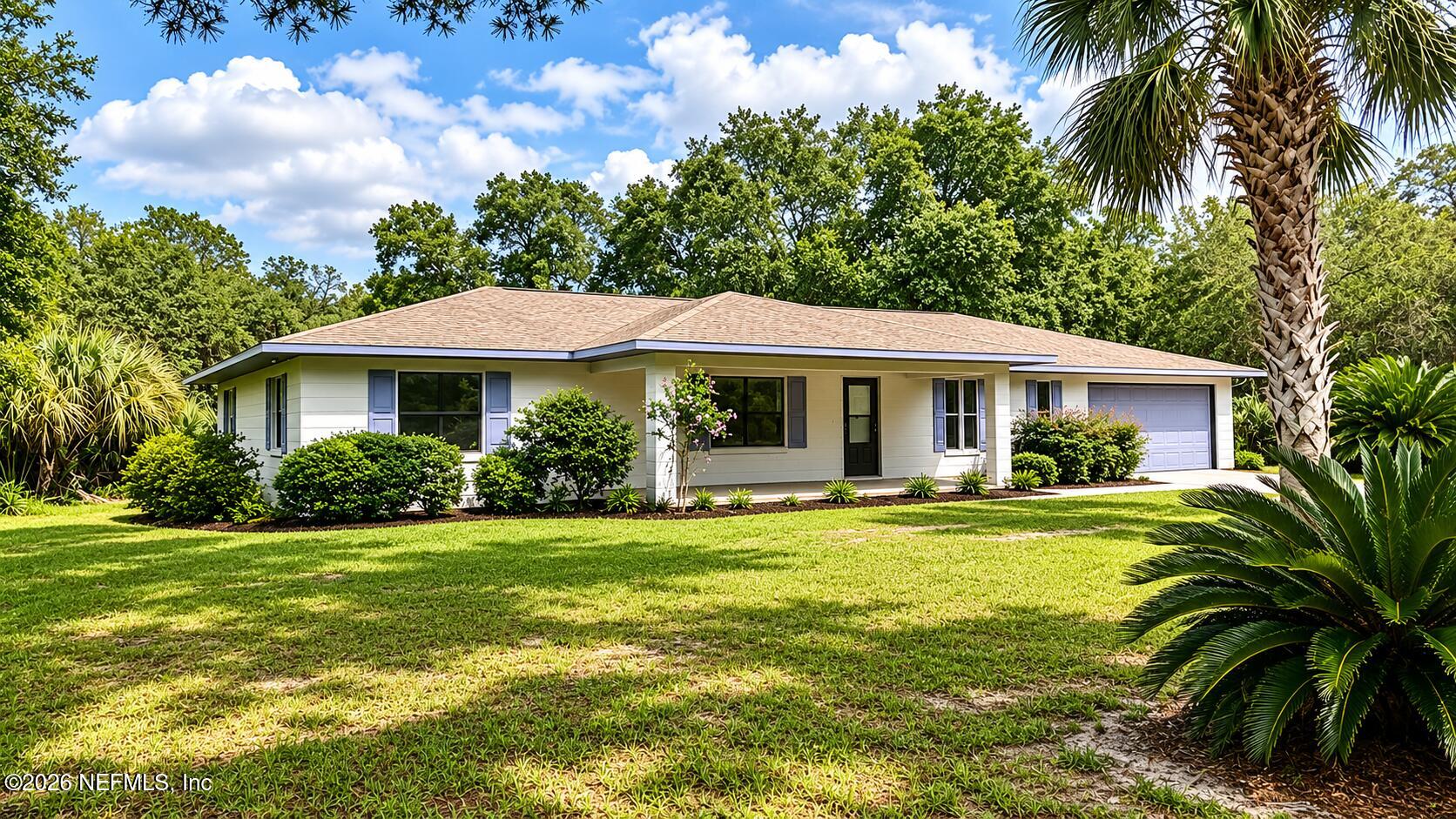 850 Cousintown Road Interlachen, FL 32148 - Photo 1 of 27 a front view of a house with swimming pool having outdoor seating