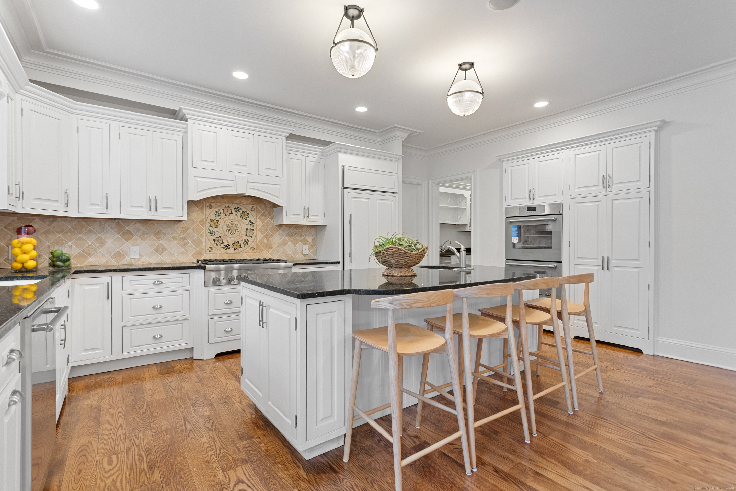 123 Greens Farms Road Westport, CT 06880 - Photo 14 of 40 a kitchen with granite countertop white cabinets and stainless steel appliances