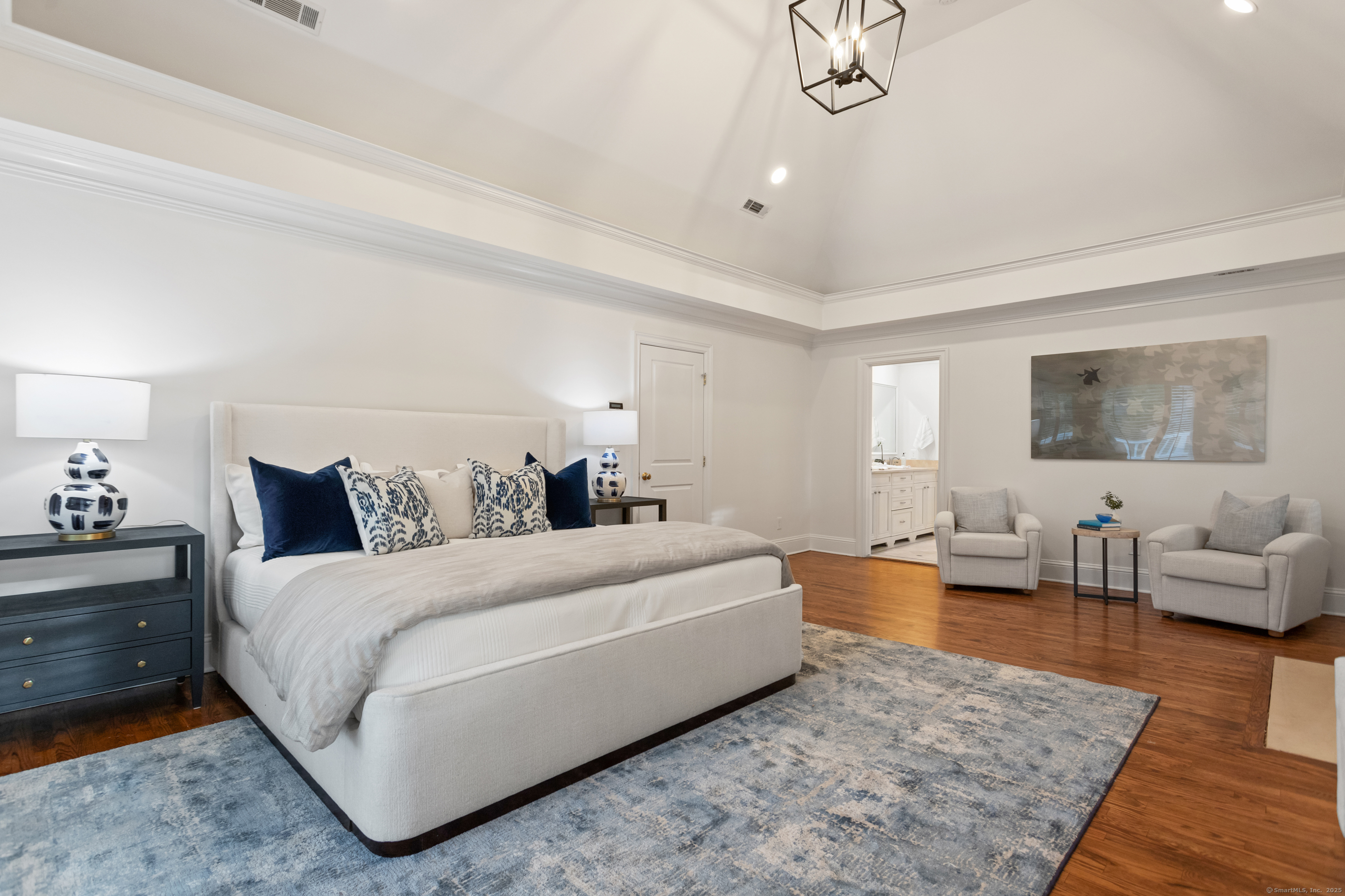 123 Greens Farms Road Westport, CT 06880 - Photo 21 of 40 a spacious bedroom with a bed a couch and wooden floor