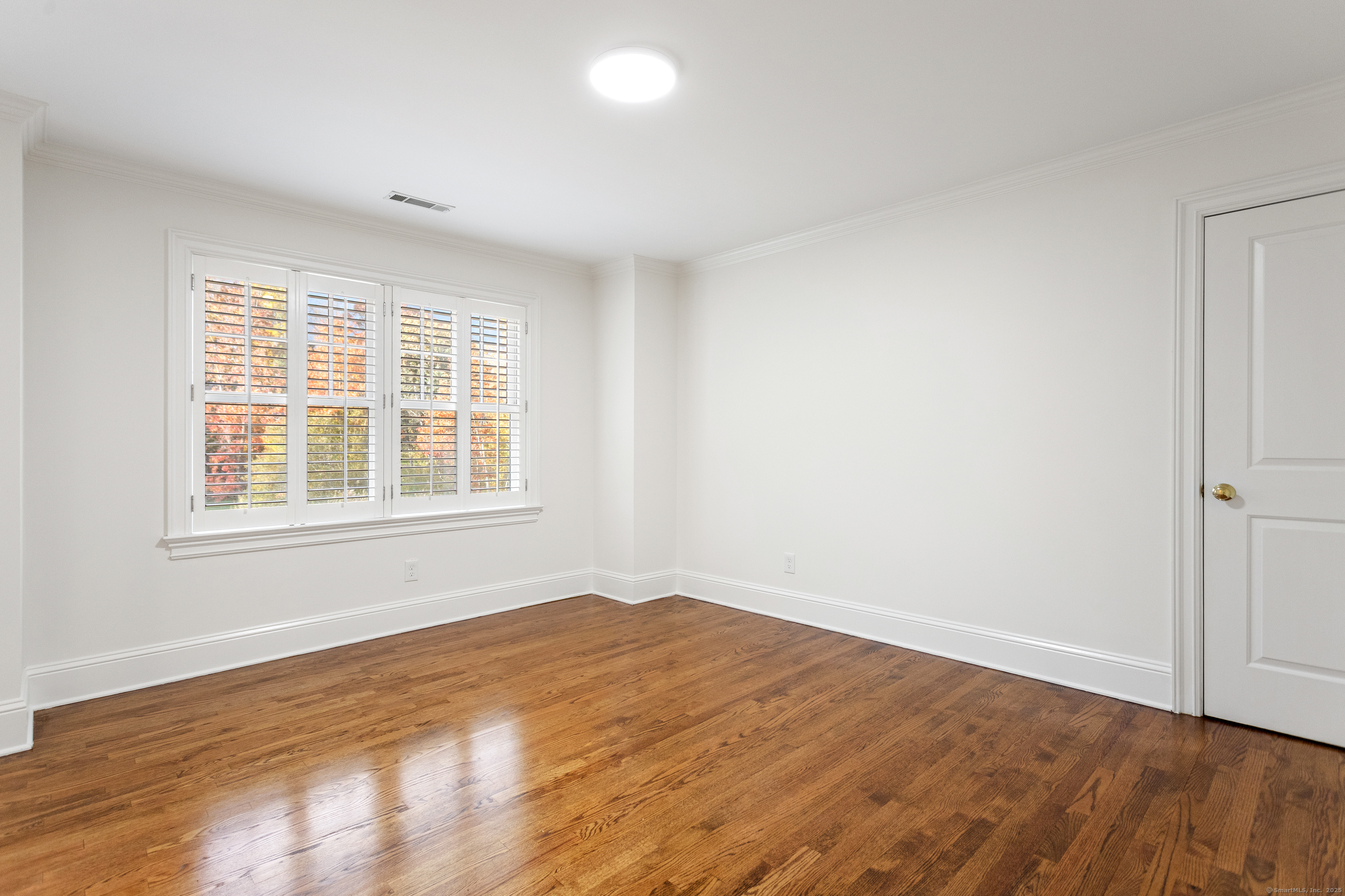 123 Greens Farms Road Westport, CT 06880 - Photo 27 of 40 an empty room with wooden floor and windows