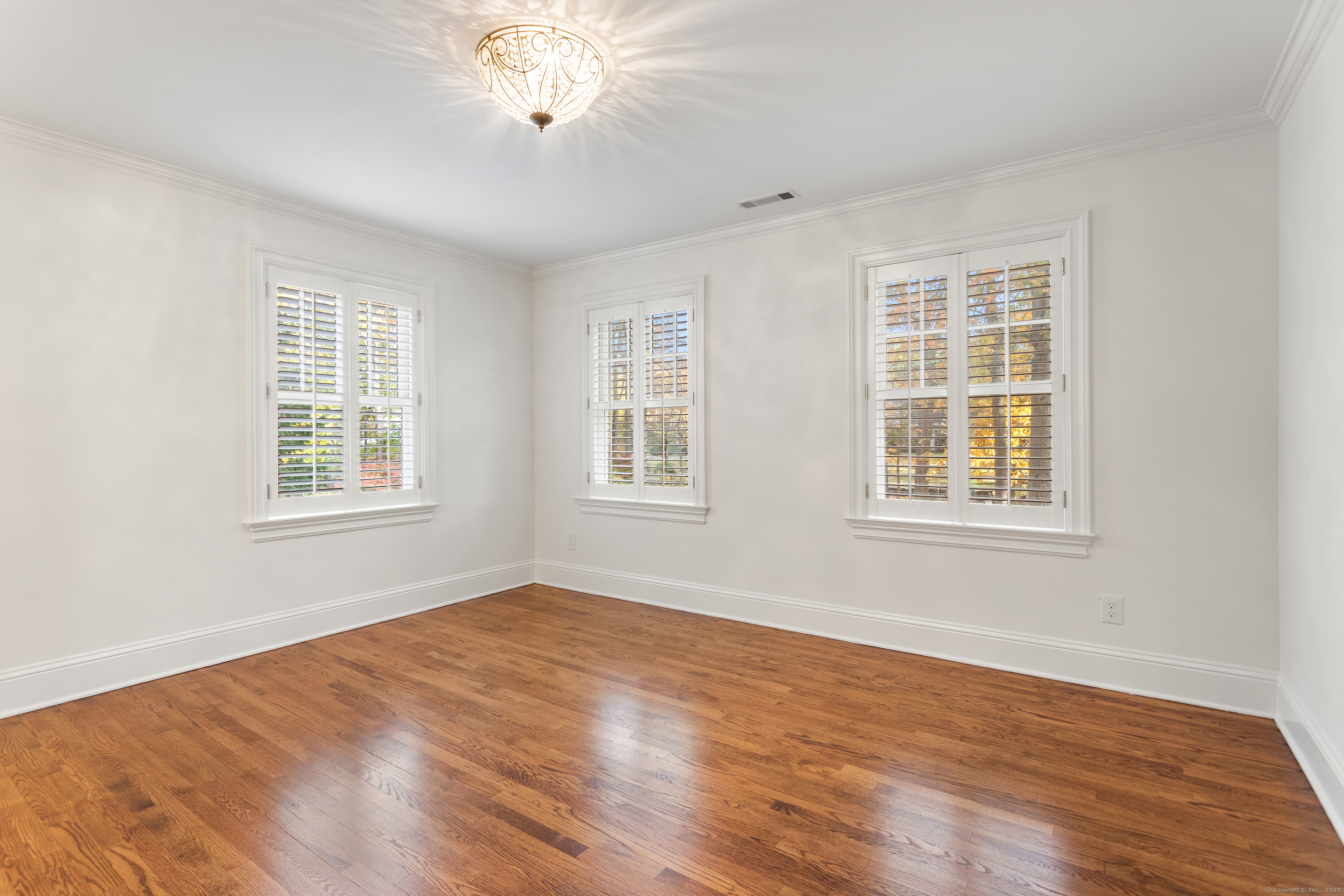 123 Greens Farms Road Westport, CT 06880 - Photo 28 of 40 a view of an empty room with wooden floor and a window